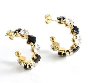 Detail view of 18K gold-plated C-shaped hoop earrings with black and clear cubic zirconia