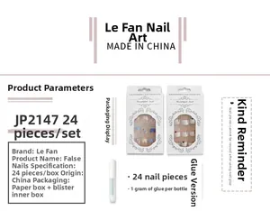 Detail view of white French gradient press-on nails set with geometric patterns and glue