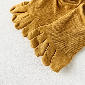 Macro detail of breathable ginger yellow knit toe socks for men showing mesh texture