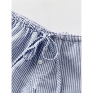 Detailed close-up of blue and white striped shorts featuring elastic waist and white drawstring