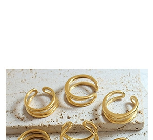 Detailed view of triple-layered golden open ring with adjustable minimalist design