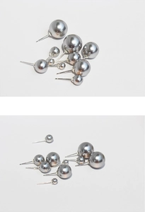 Macro view of silver gray pearl stud earrings in various sizes with high luster