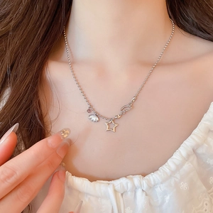 Detail of silver star necklace with cloud charms and purple crystals on ball chain