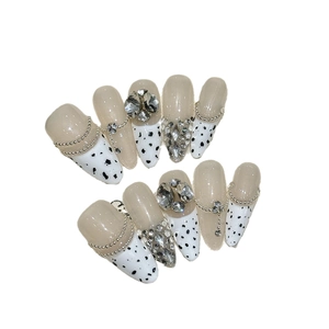 Handmade almond press-on nails set with nude base, sparkling rhinestones and metal chains