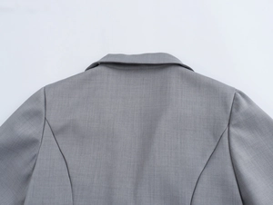 Détail du col de costume gris et des coutures d'épaule sur un ensemble tissé