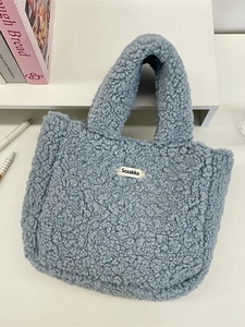 Blue fuzzy fleece tote bag with Sozakka label on a white minimalist background