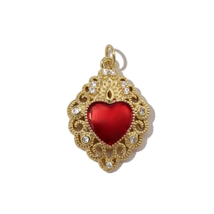 Detailed macro view of baroque gold heart pendant with red enamel and white zircon stones