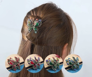 Detail showing vintage butterfly hair claws in green, red, purple, and blue colors