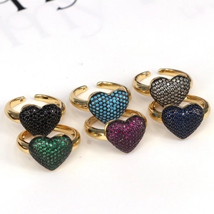 Set of six gold heart rings with colorful zircon inlays on a clean white background