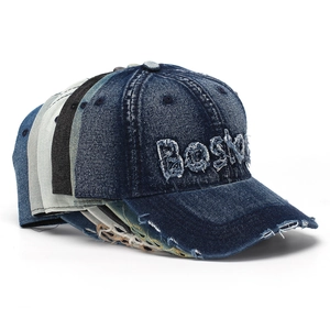 Close-up of vintage washed denim baseball caps with frayed Boston embroidery detail