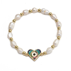 Detailed view of heart-shaped evil eye pendant with baroque pearls and gold beads