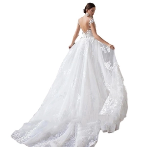 Elegant white lace wedding dress featuring backless design and long dreamy train