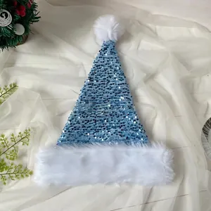 Detail of blue sequined Christmas hat with white plush trim on soft white fabric background