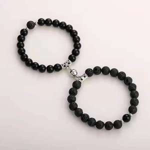 Detail of magnetic stone bracelets for couples with black lava and obsidian beads
