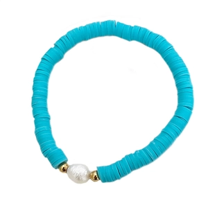 Bohemian blue heishi bead bracelet featuring a central baroque pearl and gold accents