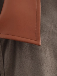 Macro detail of high-quality brown leather collar and contrasting wool fabric stitching
