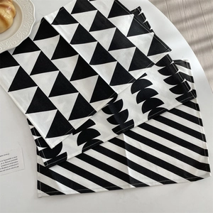 Close-up of geometric pattern placemats with minimalist black and white Nordic prints