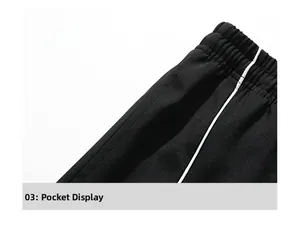 Detail of high-waisted black casual pants featuring side pockets and elastic waistband
