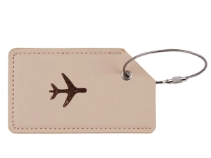 Close-up of beige leather luggage tag with dark brown airplane debossing and steel wire