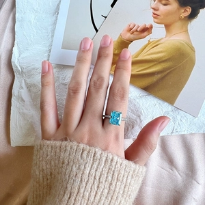 S925 silver ring featuring a large rectangular blue zircon on a hand with sweater