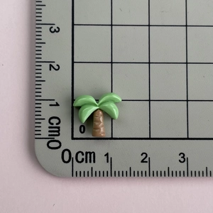 Detailed scale view of a mini resin coconut tree accessory for nail art and jewelry making