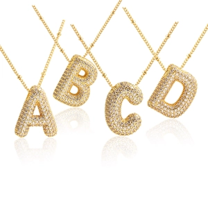 Golden balloon initial necklaces with pavé zircon letter pendants A, B, C, D in a row