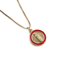 Golden necklace featuring a Saint Mary pendant with red enamel border on white backdrop