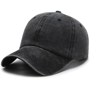 Detailed side view of washed black cotton baseball cap showing vintage fabric texture