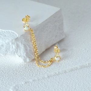 Detail of 925 silver gold chain earrings with opal stones for double ear piercings