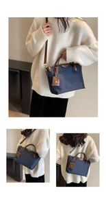 Detail of high-density nylon tote bag with leather handles and gold metal hardware