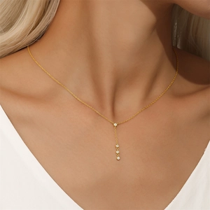 Detail of S925 silver Y-shaped gold necklace with four round sparkling cubic zirconia