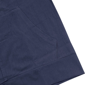 Detailed macro view of dark blue linen shirt with reinforced stitching and side pocket