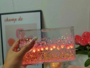 Close-up of DIY tulip night light with pink flowers and LED fairy lights inside acrylic case