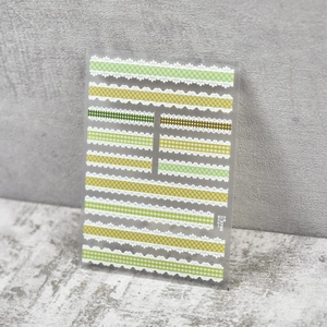 Close-up of Japanese style lace plaid embossed nail art stickers in green and yellow colors