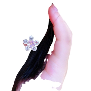 Elegant cherry blossom hair clip with pink and white crystals on a female model