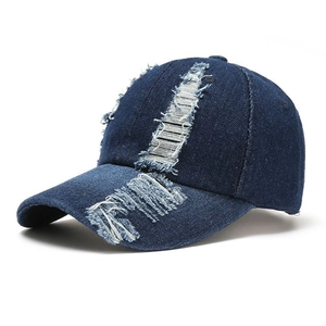 Distressed dark blue denim baseball cap with vintage ripped details for outdoor sun protection