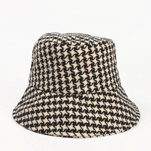 Detailed close-up showing the classic black and white houndstooth wool texture of the bucket hat