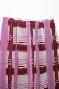 Detail view of pink purple plaid skirt featuring an invisible back zipper and waistline