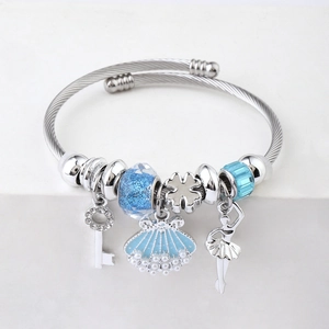 Detail of silver beaded bracelet with blue glitter charms and a ballerina pendant