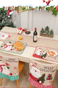 Detail of Christmas burlap placemat with snowman embroidery and rustic holiday table setting