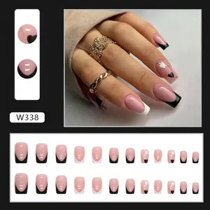 French tip press-on nails with black and white heart designs in medium square shape