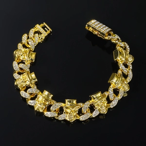 Men's punk style gold skull bracelet with diamonds on a sleek black background