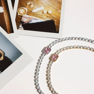 Close-up of luxury tennis bracelet featuring pink rectangle gems and cubic zirconia