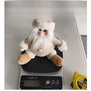 Christmas snowman plush toy weight measurement showing 39g on a digital scale