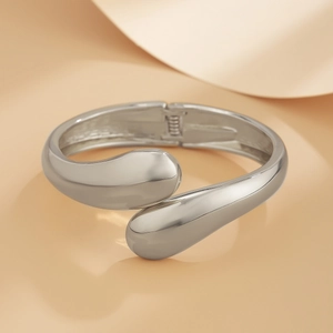 Polished silver irregular drop-end open cuff bracelet with minimalist aesthetic