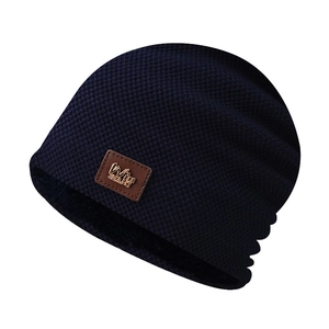 Close-up of winter knit beanie showing plaid pattern and thick black fleece lining