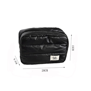 Detailed view of black quilted makeup bag showing 20x15x9.5cm dimensions and logo