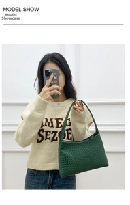 Detail shot of a dark green woven pattern shoulder bag with textured finish