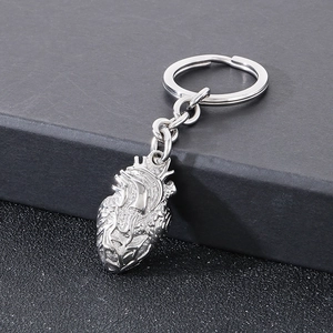 Detailed macro view of an anatomical heart pendant on a silver metal keychain