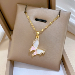 Detail of pink butterfly pendant with crystals on gold titanium necklace in a gift box